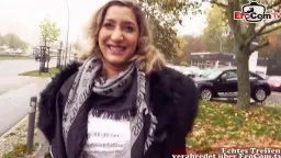 Mollige Blondine mit Tattoos lächelt frech in die Kamera auf einer herbstlichen Straße